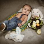 Smiling baby in Easter basket photoshoot with spring props, Kelowna family photographer