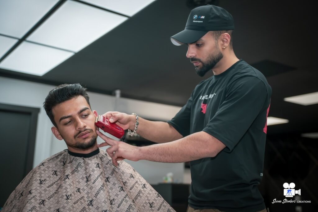 Barber detailing client's beard with trimmer, High Fade Barbers commercial photography
