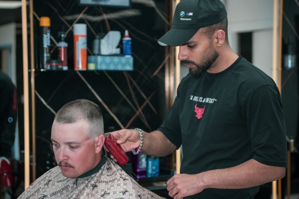 Barber giving buzz cut with trimmer, High Fade Barbers Vernon BC