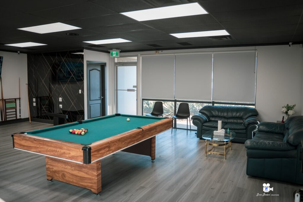 Barbershop client lounge with pool table and sofas, High Fade Barbers Vernon