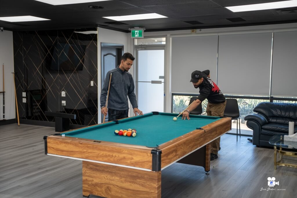 Clients playing pool in barbershop lounge, High Fade Barbers lifestyle shoot