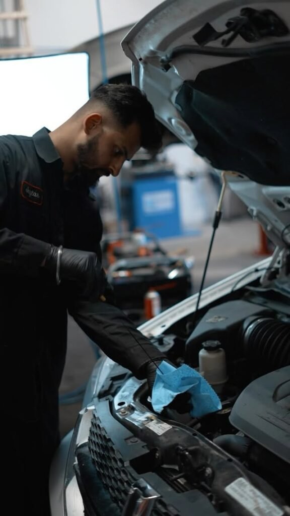 Mechanic at work under the hood, WMK Auto Repair business ad Kelowna